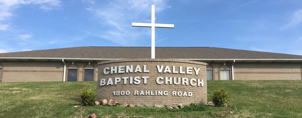 The Chenal Valley Baptist Church sign and white cross in front of the church building at 1800 Rahling Road